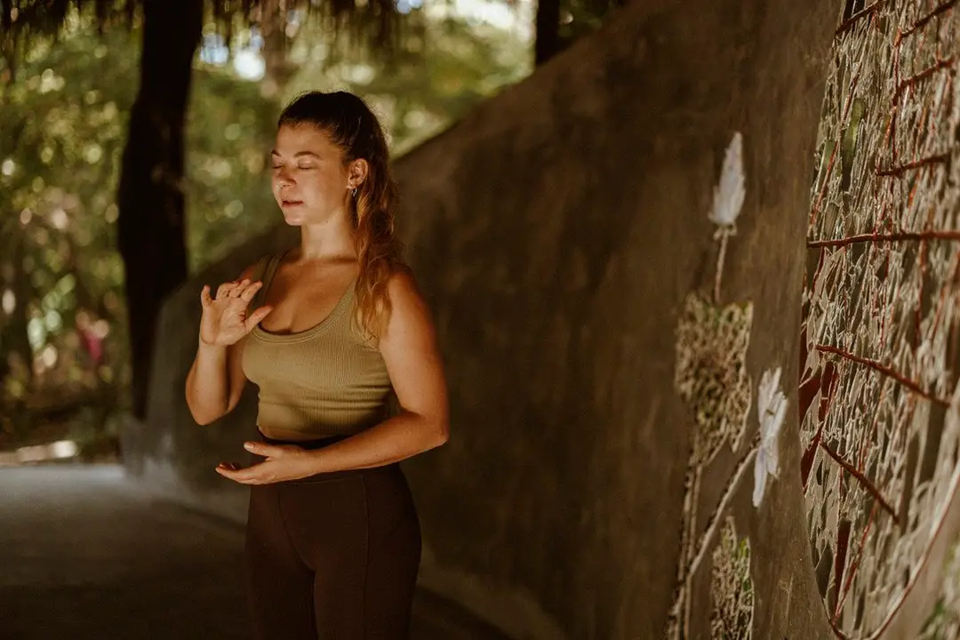 A woman practicing yoga in a jungle clearing
