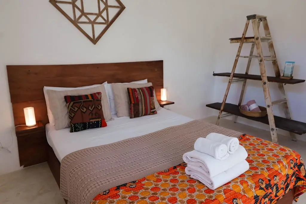 A Queen Room at Naya Nosara, with a handmade wood headboard and artisan textiles